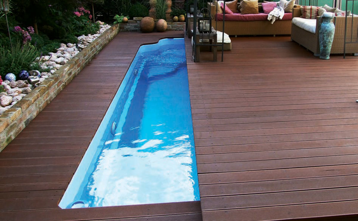 milos plain finish fibreglass pool pictured with a wooden deck